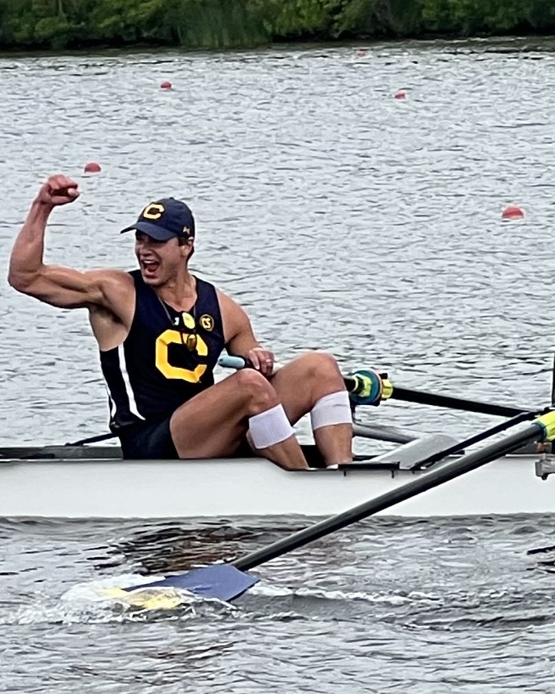 Joshua celebrating in a Cal rowing boat after a race